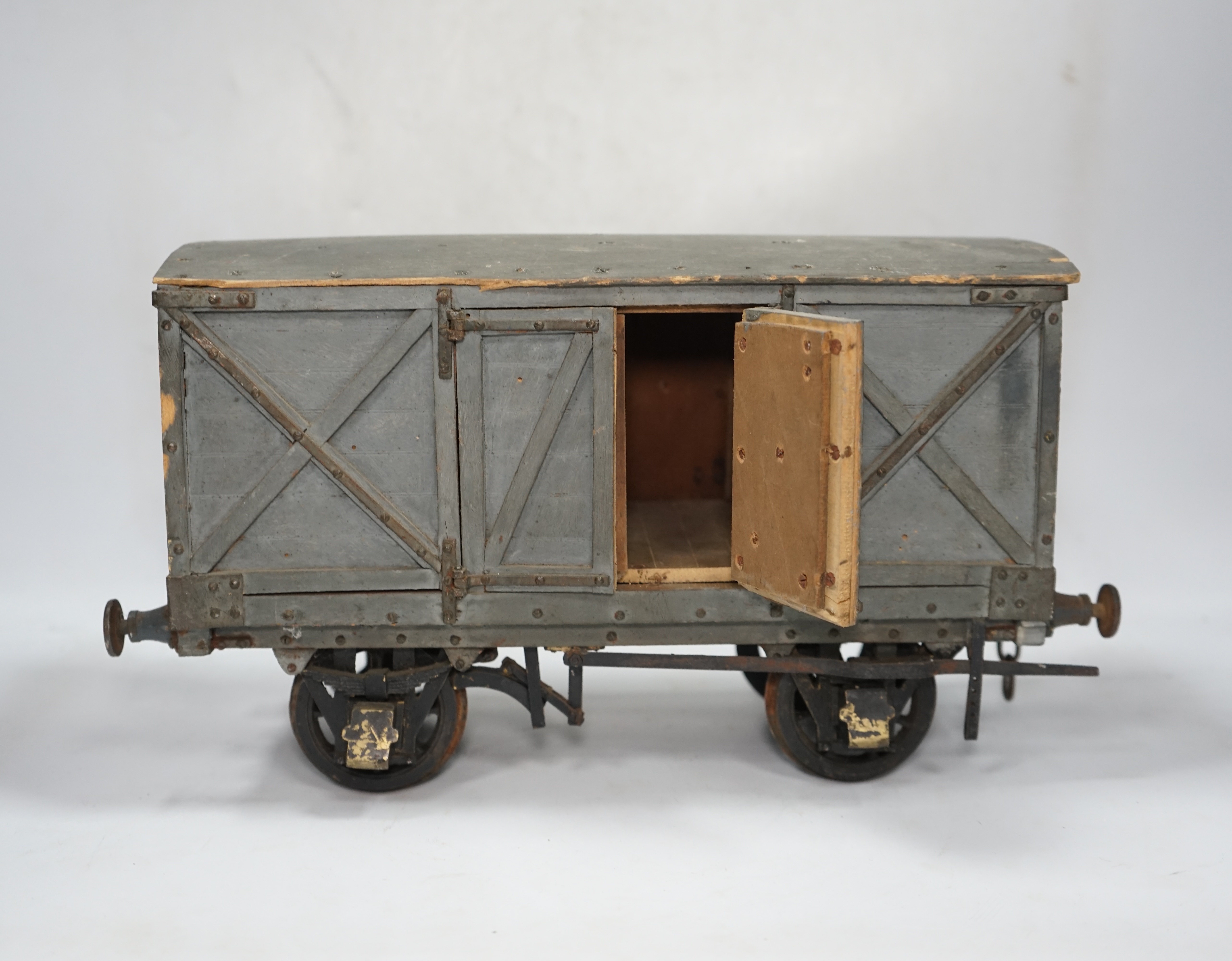 A 1950s/60s 3.5 inch gauge model railway box van, scratch built of plywood construction, with opening doors on both sides, 33cm long over the buffers, 18.5cm high. Condition - poor to fair, one buffer missing, springs mi